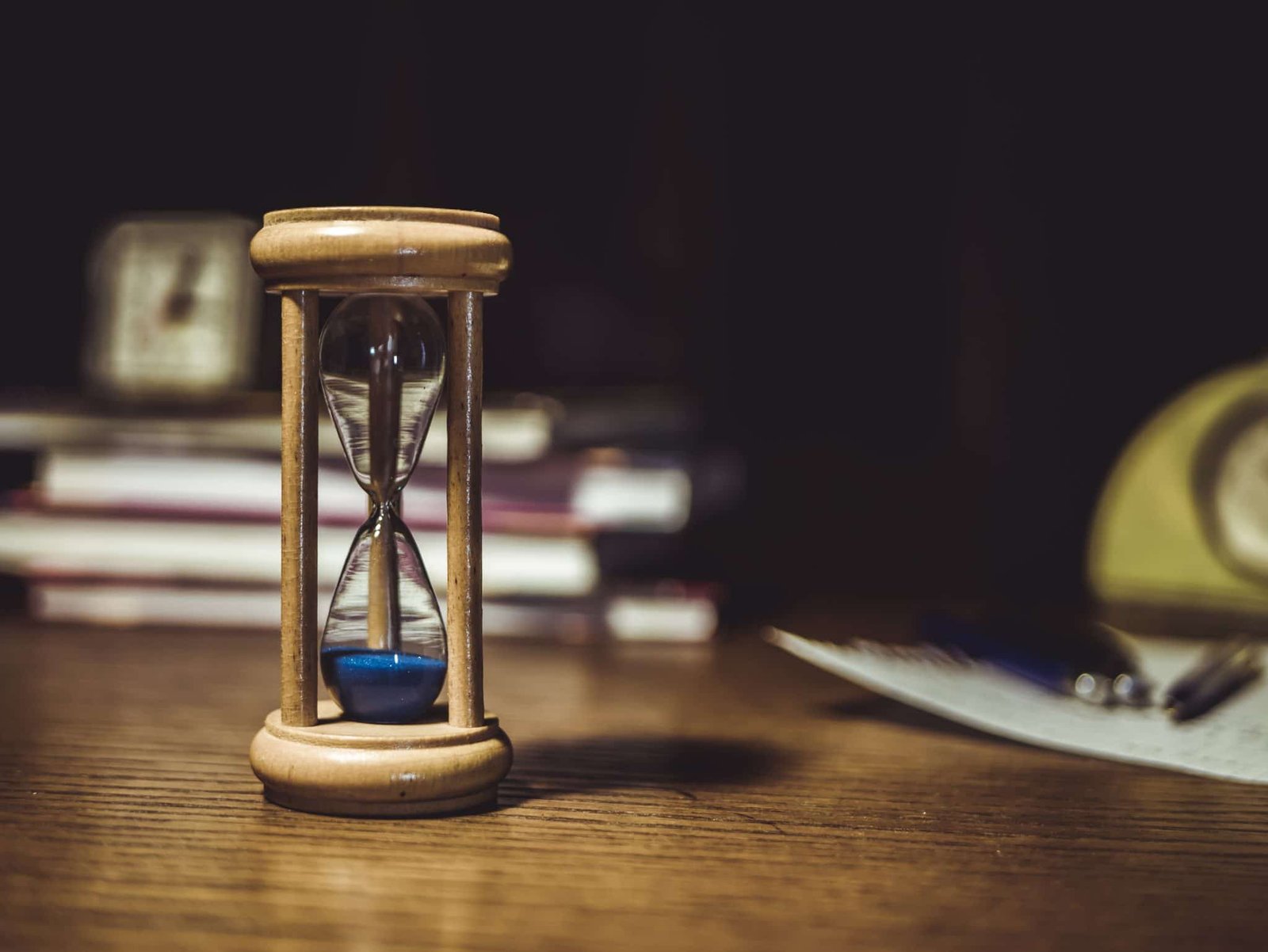 Brown hourglass on brown wooden table