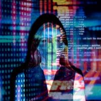 Photo of code projected over woman