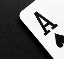 Ace of spade playing card on grey surface