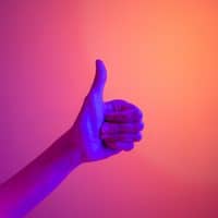 Persons hand doing thumbs up