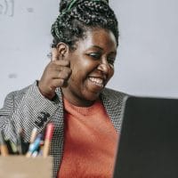 Positive black teacher showing thumb up during online test