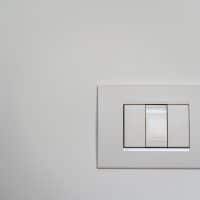 White light switch on white painted wall